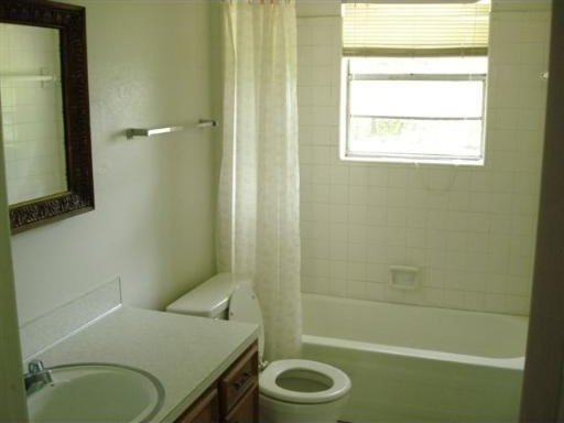 6334 Alameda, Shreveport, LA 71119 - full bath with toilet, vanity, and shower / tub combo with curtain