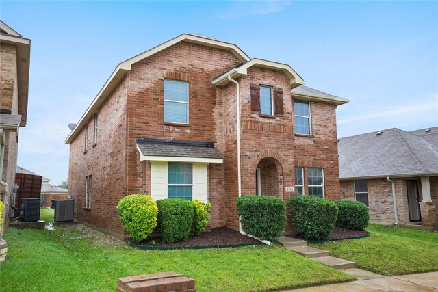3513 San Lucas Ln, Denton, TX 76208 - traditional-style house featuring central AC unit, brick siding, a front yard, and a shingled roof
