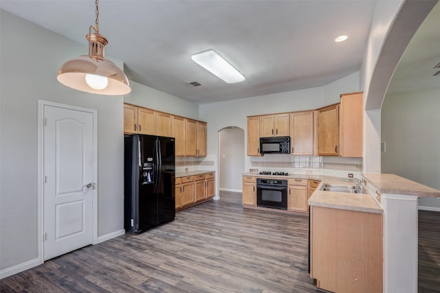 kitchen with black appliances, arched walkways, light brown cabinetry, a peninsula, and a sink