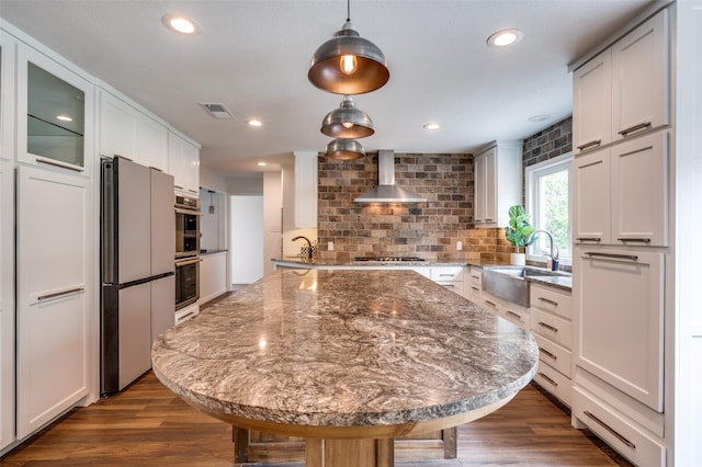6740 Fortune Rd, Fort Worth, TX 76116 - kitchen with a sink, wall chimney range hood, appliances with stainless steel finishes, a center island, and glass insert cabinets