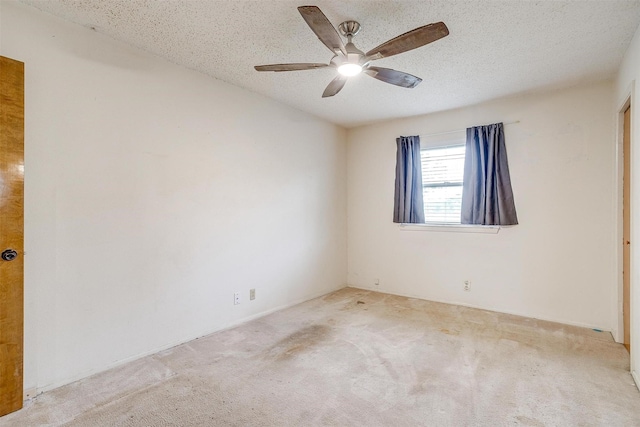 empty room featuring ceiling fan, a textured ceiling, and carpet flooring