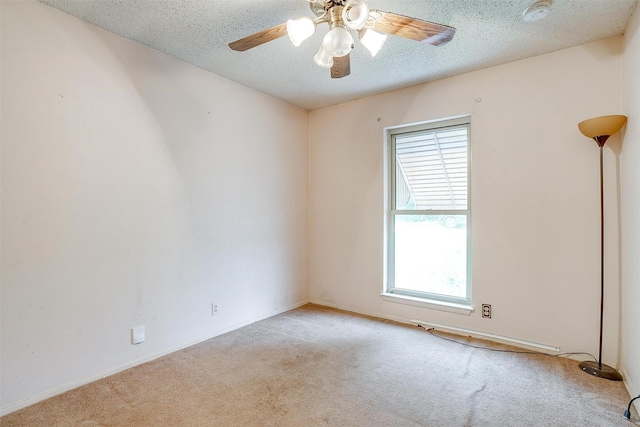 unfurnished room featuring light carpet, healthy amount of natural light, a smoke detector, and a textured ceiling