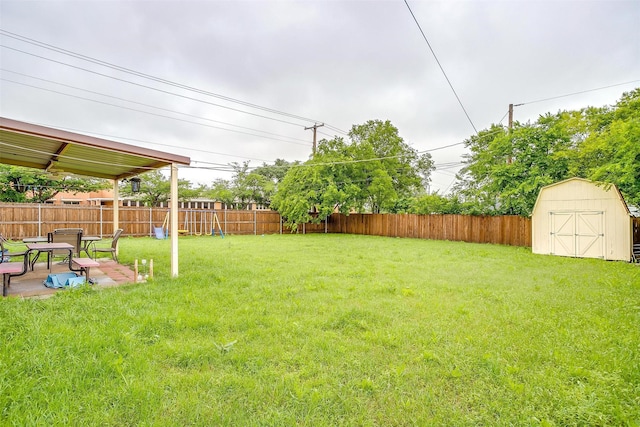 view of yard featuring a storage shed and an outbuilding