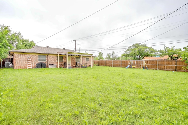 view of yard with central AC unit and a playground