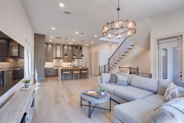 7704 Highcroft Way, Plano, TX 75024 - living area featuring a chandelier, light wood finished floors, recessed lighting, and stairway