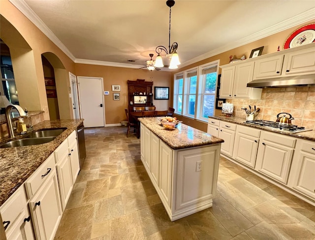 321 Fairway Meadows Dr, Garland, TX 75044 - kitchen with under cabinet range hood, stainless steel appliances, arched walkways, stone tile flooring, and tasteful backsplash