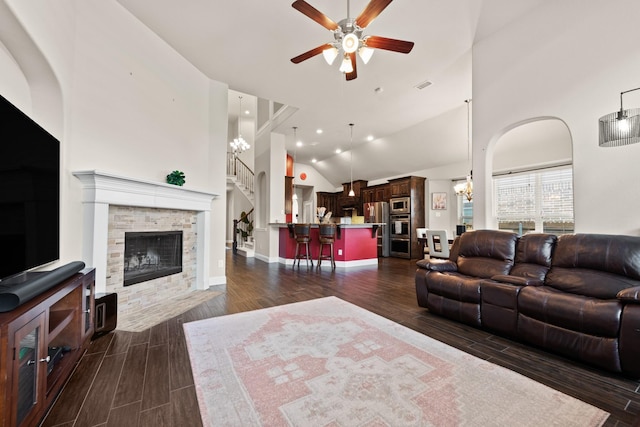 2444 Kingsgate Dr, Little Elm, TX 75068 - living area with a ceiling fan, dark wood-style flooring, stairway, a stone fireplace, and a chandelier