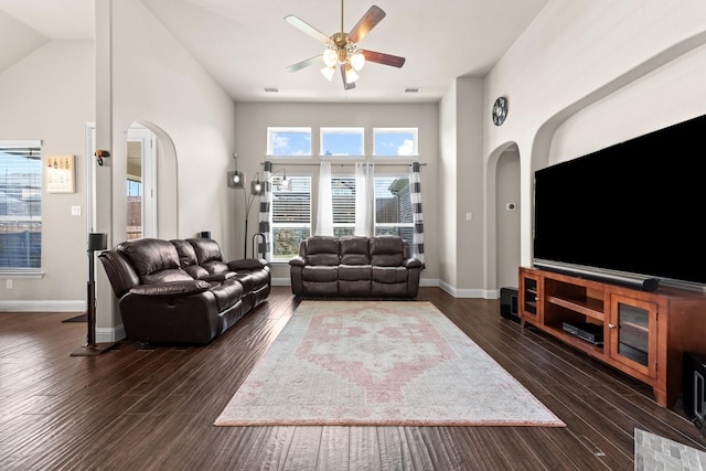 2444 Kingsgate Dr, Little Elm, TX 75068 - living room with arched walkways, a ceiling fan, wood finished floors, baseboards, and lofted ceiling