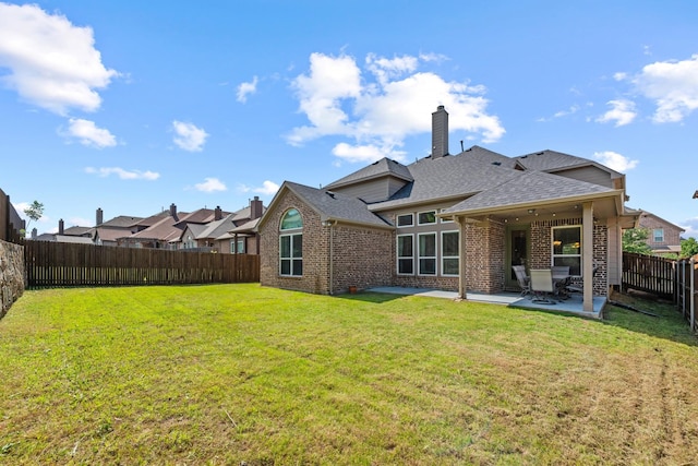 2444 Kingsgate Dr, Little Elm, TX 75068 - back of house featuring brick siding, a patio area, roof with shingles, and a chimney
