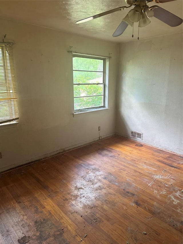 unfurnished room with hardwood / wood-style flooring and ceiling fan