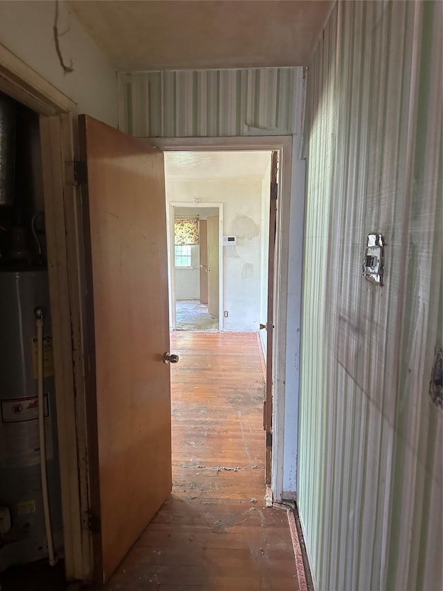 hallway with gas water heater and wood-type flooring