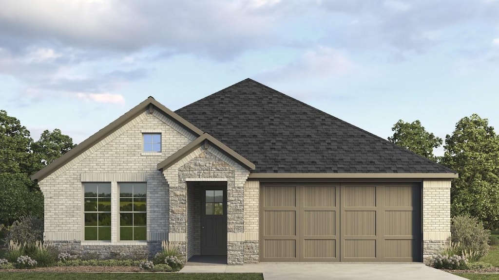 202 Michael Dr, Princeton, TX 75407 - view of front of home featuring an attached garage, concrete driveway, roof with shingles, brick siding, and stone siding