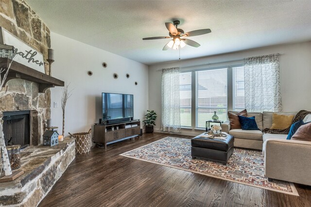 1839 Tuscany Dr, Mclendon Chisholm, TX 75032 - living area featuring wood finished floors, ceiling fan, a stone fireplace, and a textured ceiling
