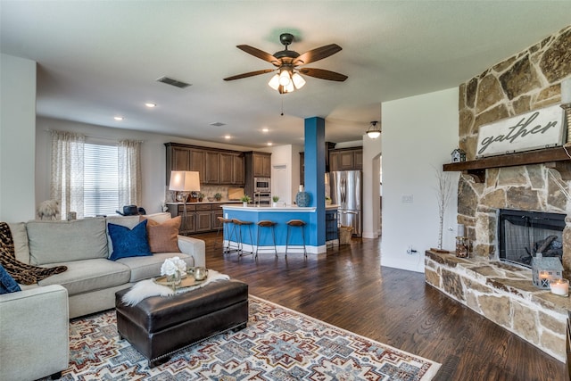 1839 Tuscany Dr, Mclendon Chisholm, TX 75032 - living area featuring ceiling fan, dark wood-style flooring, a stone fireplace, and baseboards