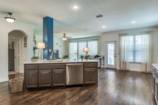 1839 Tuscany Dr, Mclendon Chisholm, TX 75032 - kitchen featuring stainless steel dishwasher, a sink, light countertops, dark wood-style flooring, and baseboards