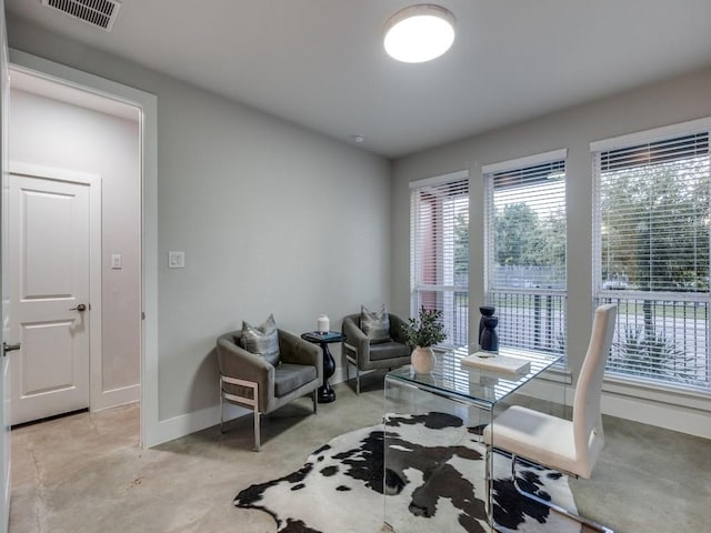 dining area featuring baseboards and concrete flooring