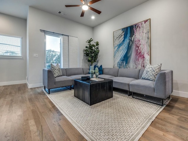 living room featuring ceiling fan, wood finished floors, baseboards, and recessed lighting