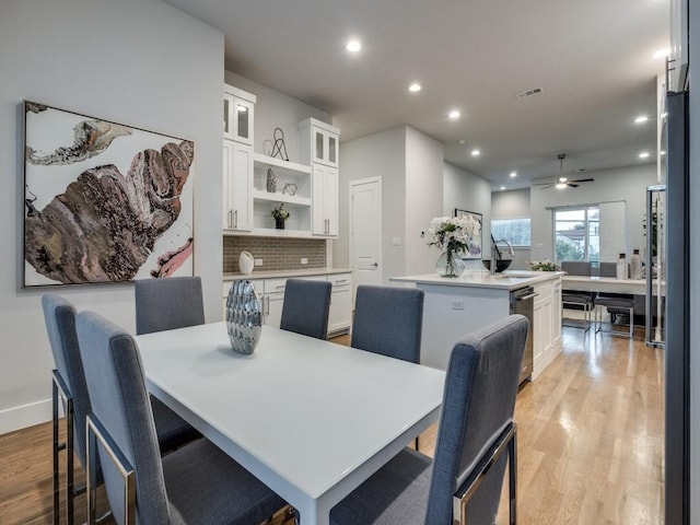 dining space with light wood-style floors, ceiling fan, recessed lighting, and baseboards