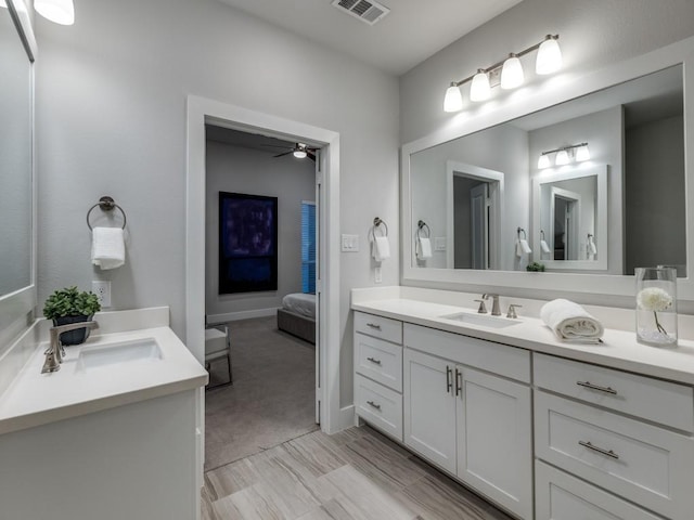 ensuite bathroom with vanity and a ceiling fan