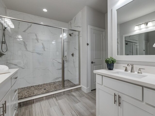 1129 Manderly Ct, Dallas, TX 75204 - full bath featuring a marble finish shower, vanity, recessed lighting, and baseboards