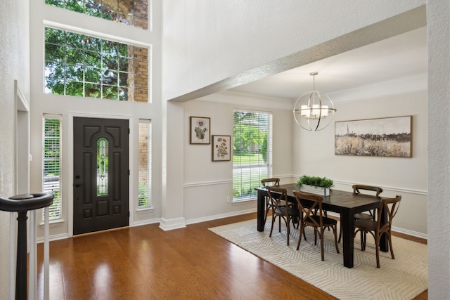 2805 Bitterroot Ct, Plano, TX 75025 - foyer featuring wood finished floors, a chandelier, baseboards, and crown molding