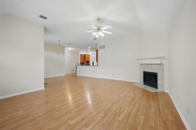 4416 Heath Ct, Plano, TX 75024 - unfurnished living room featuring light wood finished floors, ceiling fan, a fireplace, lofted ceiling, and baseboards