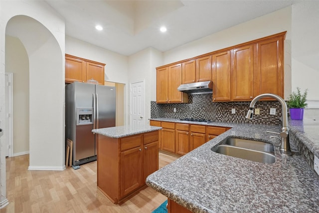 4416 Heath Ct, Plano, TX 75024 - kitchen featuring stainless steel refrigerator with ice dispenser, under cabinet range hood, a sink, light wood-style floors, and black electric stovetop