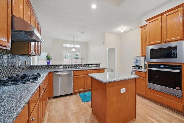 4416 Heath Ct, Plano, TX 75024 - kitchen with appliances with stainless steel finishes, wall chimney range hood, a sink, light wood-type flooring, and recessed lighting