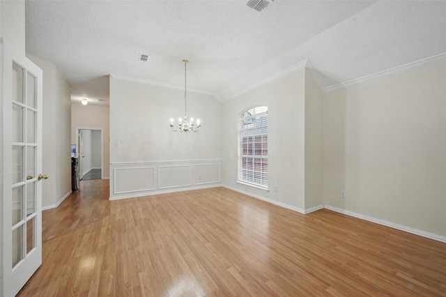 4416 Heath Ct, Plano, TX 75024 - unfurnished dining area with ornamental molding, light wood-type flooring, a chandelier, and a textured ceiling