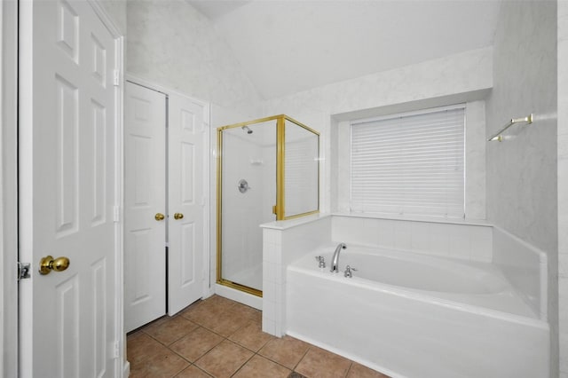 4416 Heath Ct, Plano, TX 75024 - full bathroom featuring tile patterned flooring, a shower stall, a garden tub, vaulted ceiling, and a closet