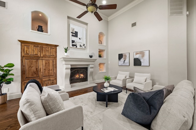 1665 Florence Rd, Keller, TX 76262 - living room with a ceiling fan, ornamental molding, wood finished floors, a warm lit fireplace, and built in shelves