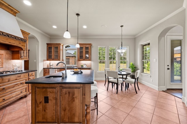 1665 Florence Rd, Keller, TX 76262 - kitchen featuring arched walkways, a sink, dark countertops, light tile patterned floors, and recessed lighting
