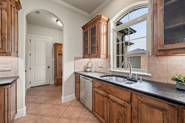 1665 Florence Rd, Keller, TX 76262 - kitchen with stainless steel dishwasher, a sink, dark countertops, light tile patterned floors, and ornamental molding
