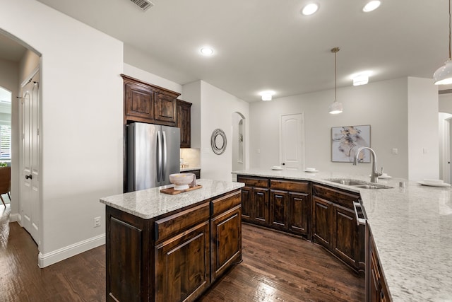 7020 Benjamin Way, Colleyville, TX 76034 - kitchen featuring freestanding refrigerator, arched walkways, dark wood-style flooring, and recessed lighting