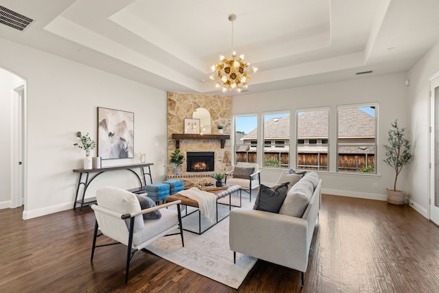 7020 Benjamin Way, Colleyville, TX 76034 - living room featuring a tray ceiling, dark wood-type flooring, and a fireplace