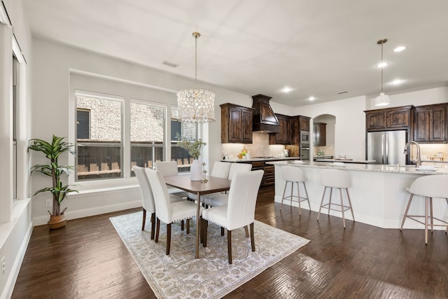 7020 Benjamin Way, Colleyville, TX 76034 - dining area featuring recessed lighting, arched walkways, a chandelier, and dark wood finished floors