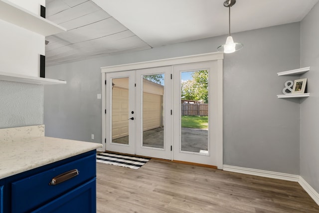 723 Westover Dr, Richardson, TX 75080 - doorway to outside featuring french doors, light wood-style flooring, and baseboards
