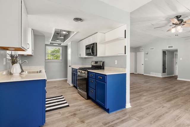 723 Westover Dr, Richardson, TX 75080 - kitchen featuring blue cabinets, stainless steel gas range, ceiling fan, light wood-type flooring, and baseboards