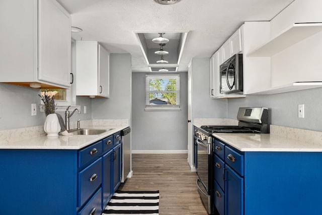 723 Westover Dr, Richardson, TX 75080 - kitchen featuring appliances with stainless steel finishes, blue cabinets, a sink, and white cabinetry