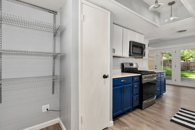 723 Westover Dr, Richardson, TX 75080 - kitchen featuring stainless steel gas range, blue cabinetry, black microwave, light wood finished floors, and white cabinetry