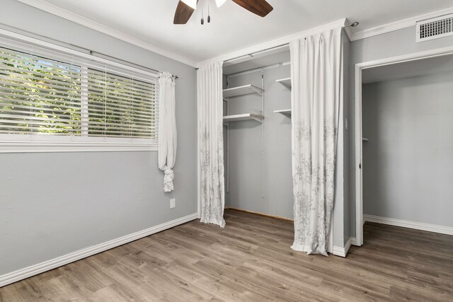 723 Westover Dr, Richardson, TX 75080 - unfurnished bedroom featuring crown molding, wood finished floors, baseboards, a ceiling fan, and a closet