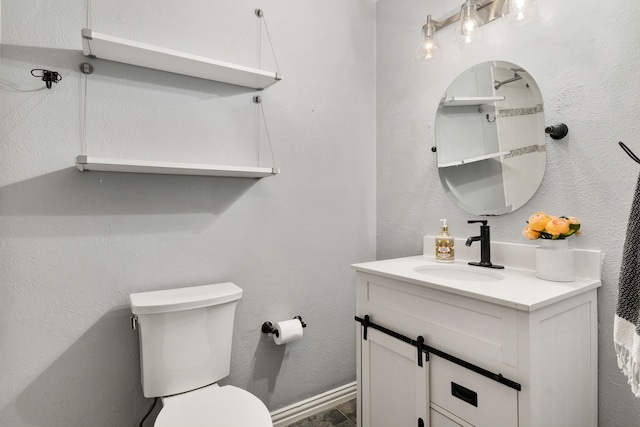 half bathroom featuring toilet and vanity