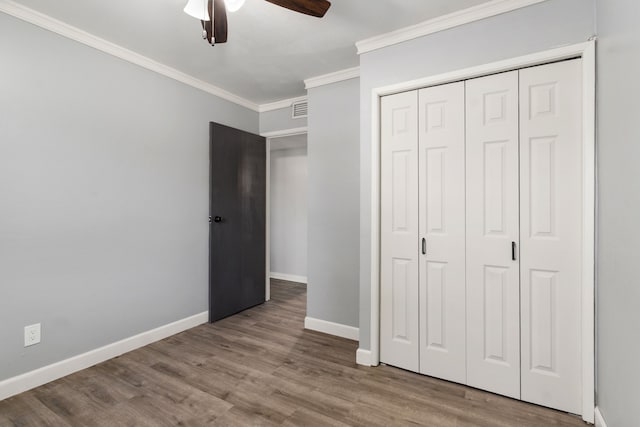 723 Westover Dr, Richardson, TX 75080 - unfurnished bedroom with ornamental molding, baseboards, wood finished floors, a closet, and ceiling fan
