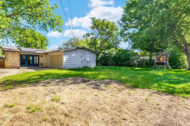 723 Westover Dr, Richardson, TX 75080 - view of grassy yard with a playground and a garage