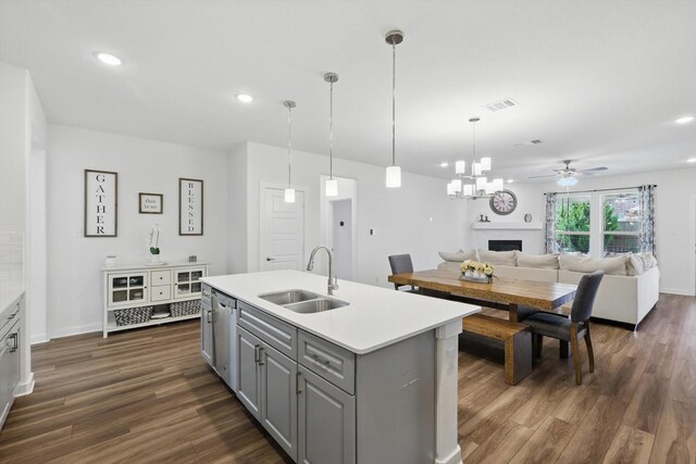 1837 Sebright Trl, Fort Worth, TX 76052 - kitchen with a sink, gray cabinets, a fireplace, dark wood-type flooring, and recessed lighting