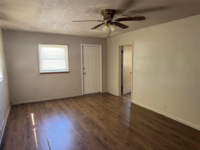 425 S 1st St W, Clyde, TX 79510 - empty room with a ceiling fan, dark wood-style flooring, baseboards, and a textured ceiling