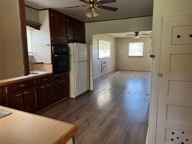 425 S 1st St W, Clyde, TX 79510 - kitchen featuring white appliances, a ceiling fan, dark wood-style floors, a wall mounted air conditioner, and baseboards