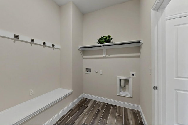 washroom featuring electric dryer hookup, washer hookup, dark wood-style floors, baseboards, and gas dryer hookup