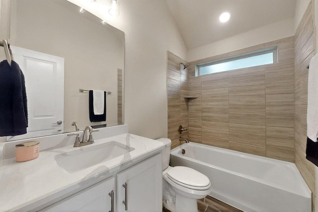 full bathroom featuring shower / bath combination, toilet, vaulted ceiling, and vanity