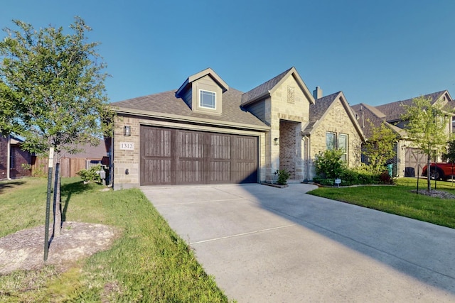 view of front of home featuring a front lawn, concrete driveway, and brick siding